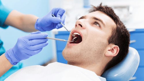 patient during cleaning and exam in Madison, AL